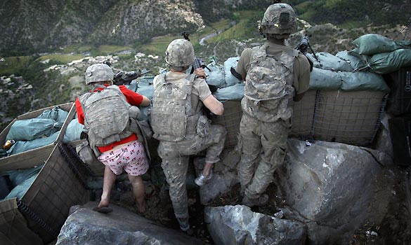 Spc. Zachery Boyd, wears pink 'I love NY' boxer shorts in a firefight with Taliban militants after rushing out of bed to join his fellow platoon members - Photo by David Guttenfelder/AP