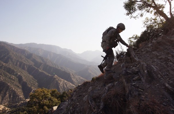 U.S. Army SFC Isaac Migli, 26, walks up a mountainside towards an American outpost in the Korengal Valley October 24, 2008 in the Kunar Province of eastern Afghanistan - John Moore/Getty Images